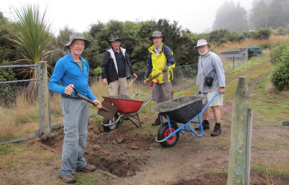 Orokonui volunteers building the kiwi fence.