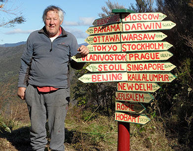 Rod Eatwell standing next to a sign. 