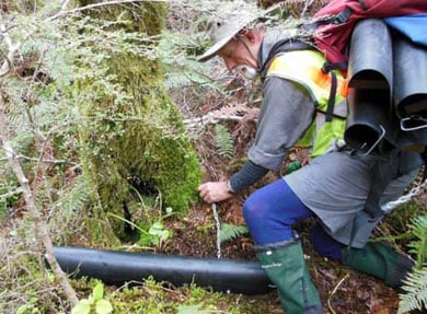 Man placing a tracking tunnel. 