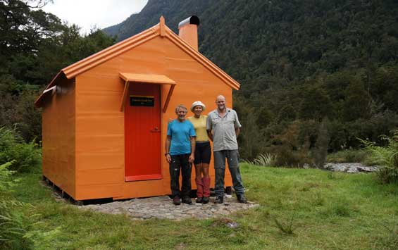 Tunnel Creek Hut on the West Coast gets a refresh, with assistance from the Recreation Consortium, thanks to outdoor enthusiasts Geoff Spearpoint (left), Liz Stephson and Hugh Van Noorden. 