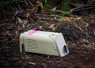 A white plastic tube with a hole in one end and a red piece of plastic sticking out of the top of it.