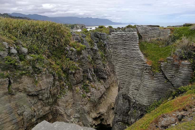 View of unusual looking groved rocks nestled in hills.