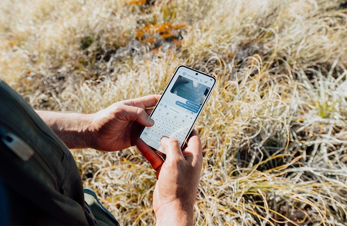 Ranger Heath Sinclair using One NZ&rsquo;s satellite to mobile connection to get in touch with home base.