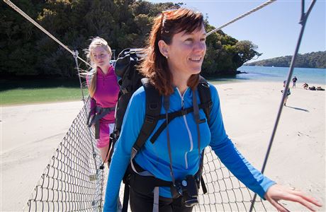 Trampers on bridge, Rakiura Track.