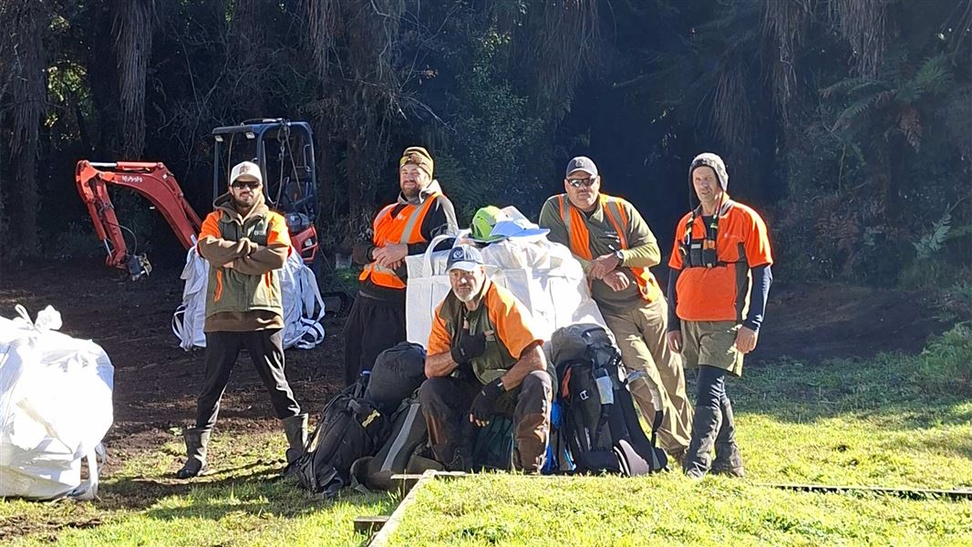 The DOC team at the Pouri Hut site, retiring ranger Shane Woolley centre front. 