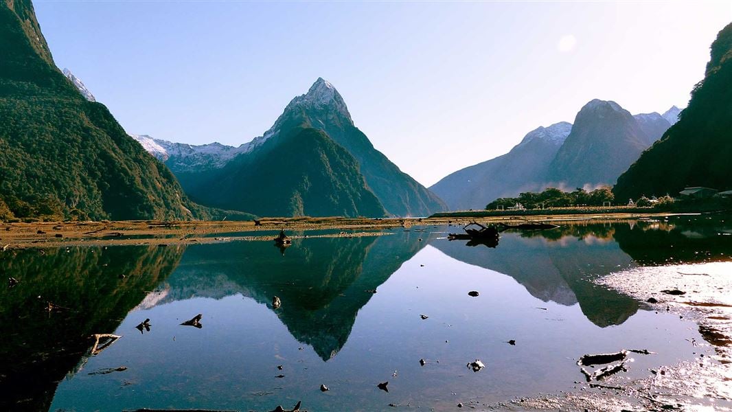 Mountains reflected on water at Milford Sound. 