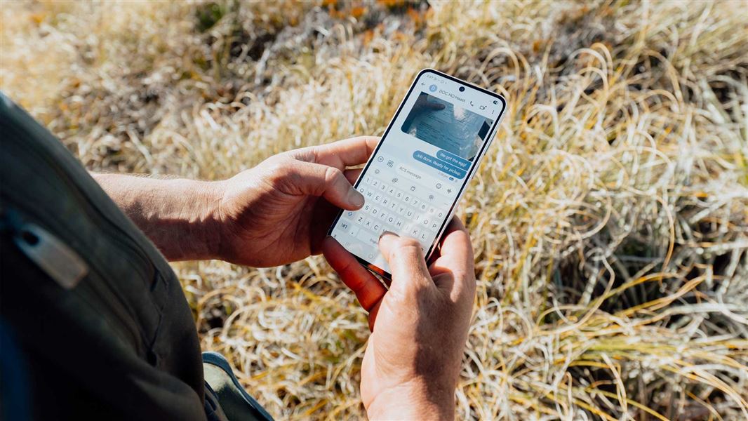 Mobile phone in a rangers hands with a text message shown. 