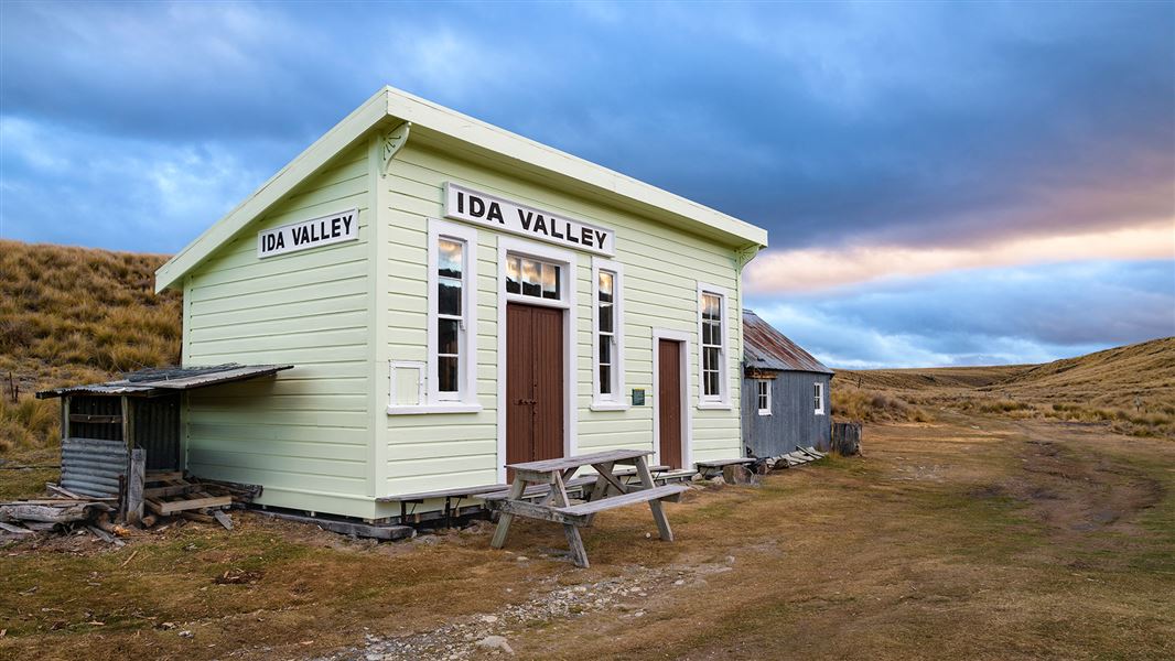 Small wooden building connected to corrugated iron building