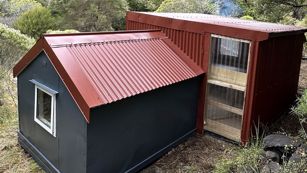 Small charcoal and red hut. 