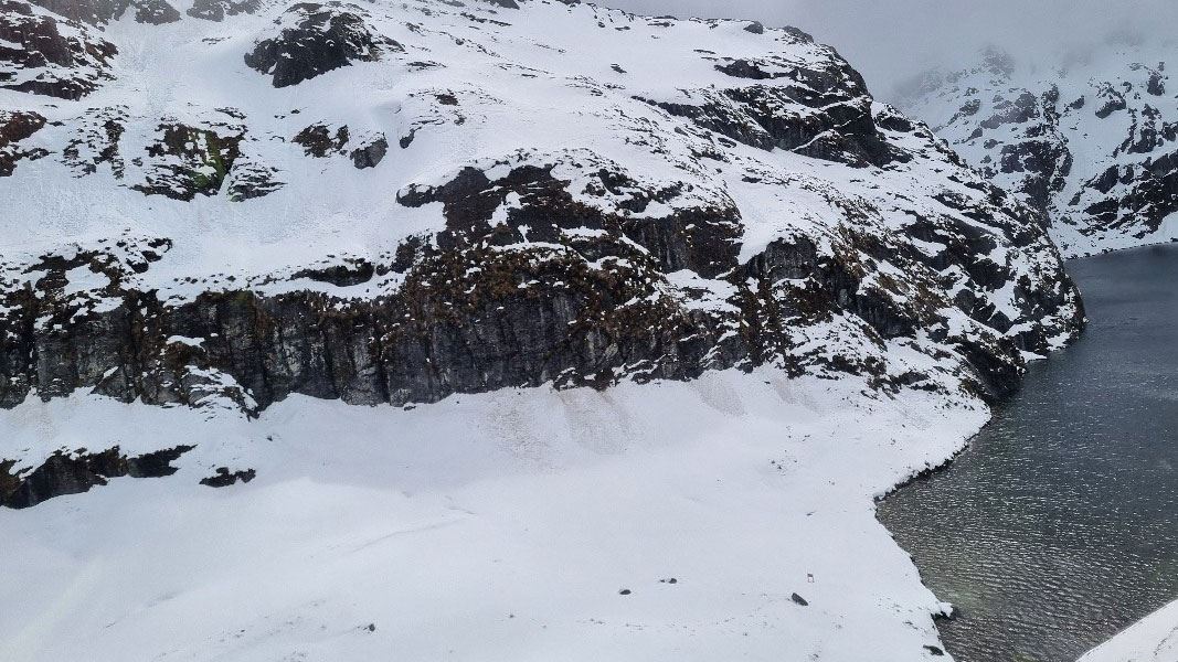 Snow covered mountains and a lake. 