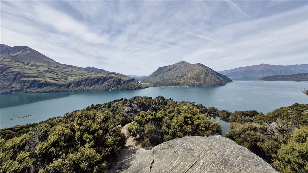 View of a lake surrounded by hills.
