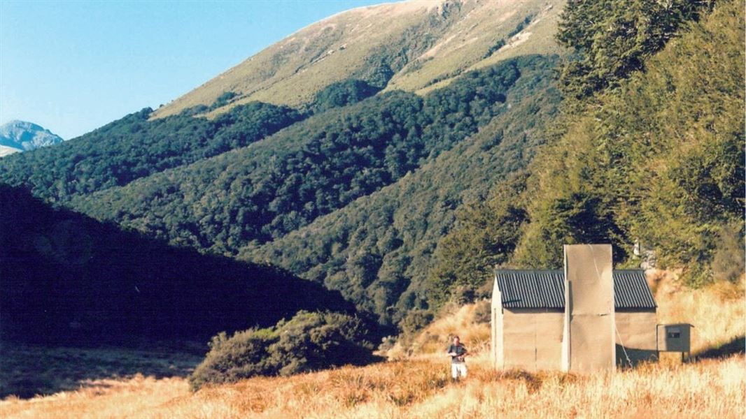 Cromel Branch Hut with hills in the background.