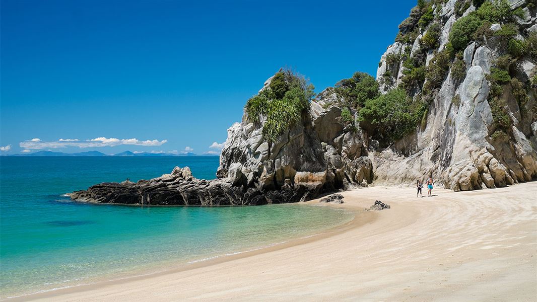  View along a beach on the Abel Tasman Coastal Track Great Walk, visitors in the distance. 