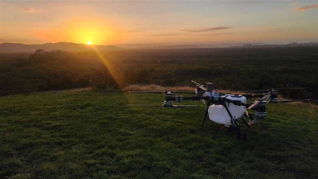 Sunset on a hill with a large drone in the foreground. 