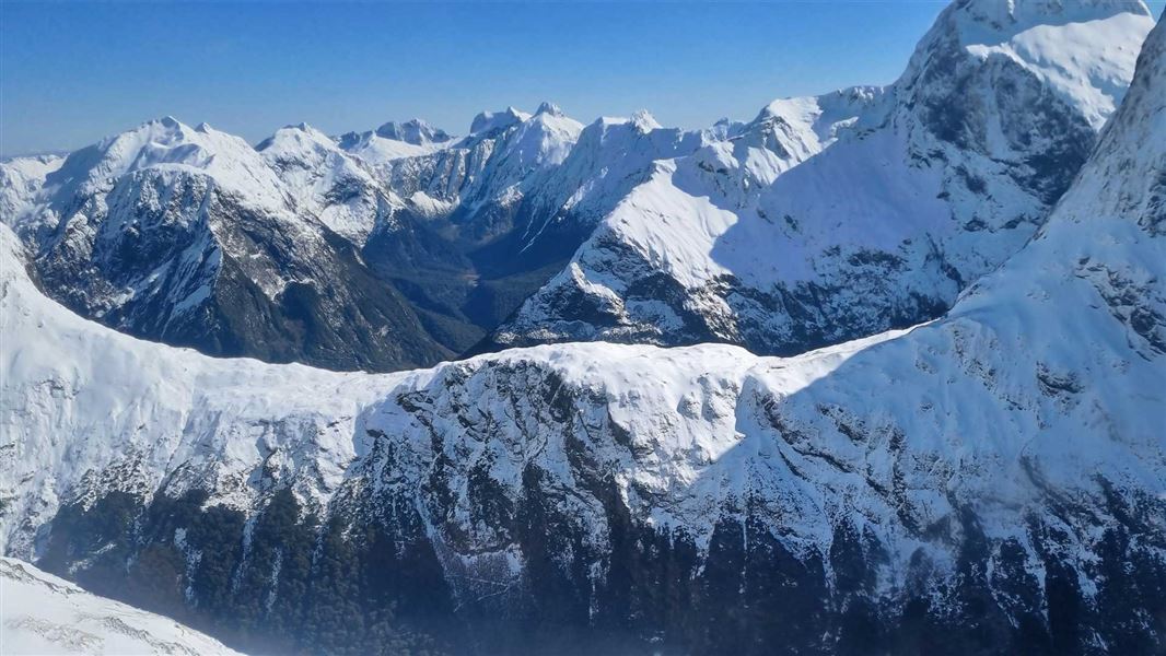 Snow capped mountain tops from a helicopter. 
