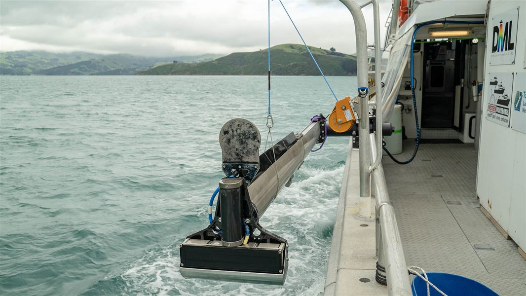 A boat with mapping apparatus sails off the coast.