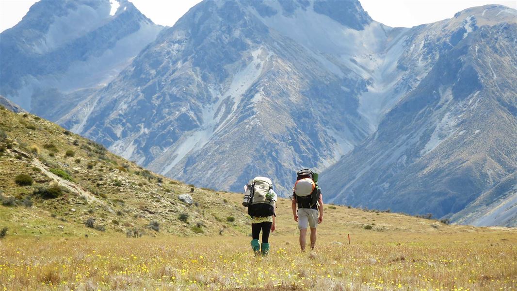 Two trampers hike parallel to the Mavora River in the Mavora Lakes region. This track is part of Te Araroa trail, so an increasingly-popular destination for both kiwis and international visitors. 